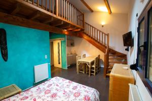 a small room with a bed and a staircase at Hôtel Ilargi in Ascain