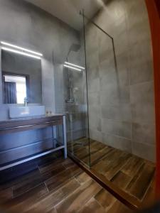 a bathroom with a glass shower and a sink at Luxurious Studios Nani in Kranevo