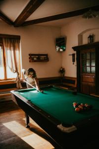 une femme debout devant un billard dans l'établissement RANČ JUREŠ, à Ljutomer