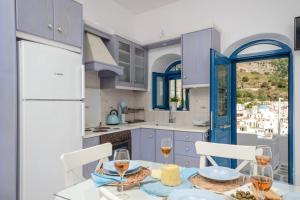a kitchen with a table with two glasses of wine at Apanemo in Kóronos