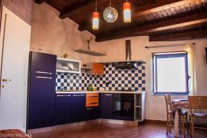 a kitchen with a blue refrigerator and a table at B&B al centro storico in Troina