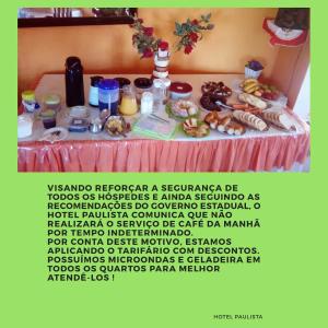 a poster of a table with food on it at Hotel Paulista in Barra Velha