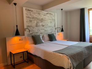 Ліжко або ліжка в номері Hotel Cims de Camprodon