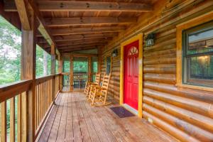 a front porch of a cabin with a red door at Afternoon Delight 1 Bedroom Cabin Rental between Gatlinburg and Pigeon Forge Great Couple getaway in Sevierville