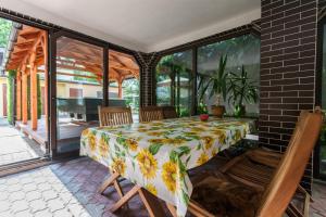 a conservatory with a table and chairs on a patio at Wypoczynek Roda in Pobierowo