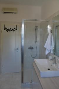 a white bathroom with a shower and a sink at Apartment Seven in Split +18 photos
