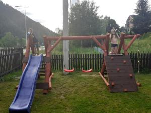 two young girls playing on an outdoor playground at Domek Jarmuta in Szlachtowa