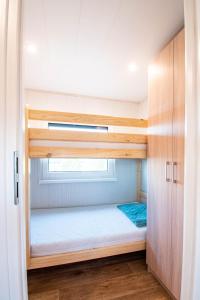 a bedroom with a bunk bed with a window at Szuflandia in Giżycko