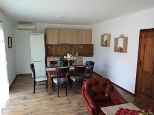 a kitchen and dining room with a table and chairs at Varna Holiday in Varna City