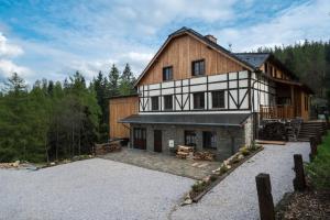 a large wooden house with a gravel driveway at Pod Gwiazdami in Świeradów-Zdrój