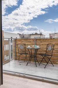 a patio with a table and chairs on a balcony at Flow Apartments Toruń in Toruń