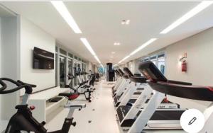 a gym with a row of treadmills at Estúdio perfeito in Curitiba