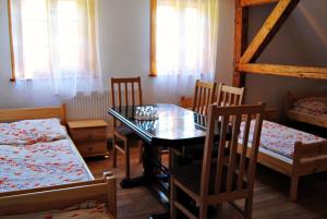 a dining room with a table and chairs and a bunk bed at Sudecka Chata in Bystrzyca Kłodzka