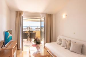 a bedroom with a bed and a view of the ocean at Steko Accomodations in Makarska