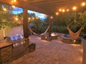 an outdoor patio with a hammock and a grill at 6-Bedroom Tudor in the Downtown Historic District in Salt Lake City