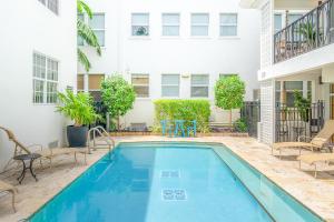 a swimming pool in front of a building at Fountain condo 2 story Pool BBQ Balcony in Miami Beach