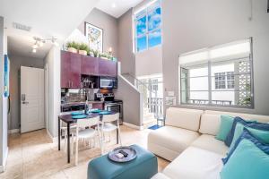 a living room with a couch and a table at Fountain condo 2 story Pool BBQ Balcony in Miami Beach