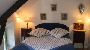 a bedroom with a bed with two pillows on it at Maison briéronne 15 mn de La Baule in Saint-Lyphard