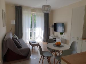 a living room with a couch and a table at Apartament Blisko Morza Gdynia in Gdynia