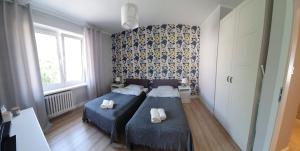 Posteľ alebo postele v izbe v ubytovaní Apartament Blisko Morza Gdynia