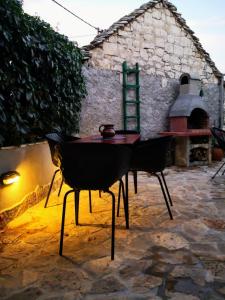 a table and chairs sitting on a stone patio at Holiday Home Little Heaven in Slatine