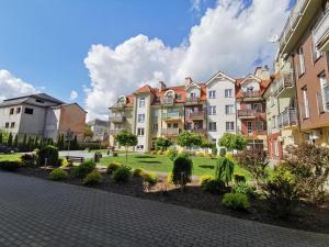 a row of apartment buildings in a park at Apartament h2o in Giżycko