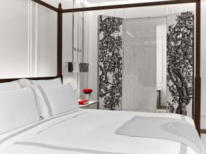a bedroom with a white bed and a shower at Baccarat Hotel and Residences New York in New York