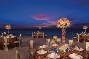 a table set up for a wedding on the beach at Secrets Royal Beach Punta Cana - Adults Only in Punta Cana