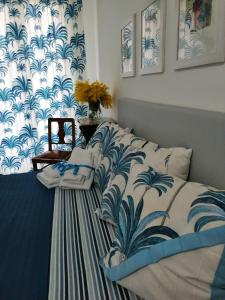 a bedroom with a bed with a blue and white blanket at Casa Ferreri in Santa Ninfa