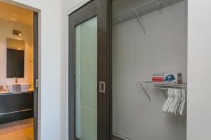 a door with a mirror in a room at Mid Century Modern Downtown Condo 30+ Night Min in Nashville +25 photos