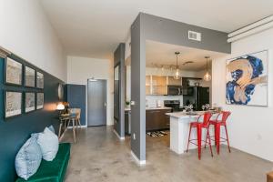 a kitchen and living room with red bar stools at Mid Century Modern Downtown Condo 30+ Night Min in Nashville