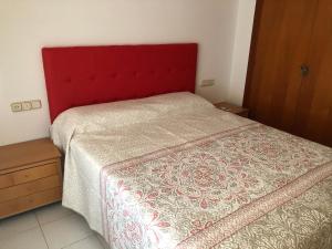 a bed with a red headboard in a bedroom at Miraplaya in Benicàssim +15 photos
