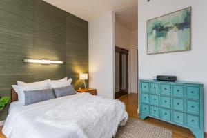 a bedroom with a large white bed and a blue dresser at Artsy Extended Retreat Downtown Nashville in Nashville