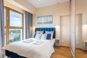 Łóżko lub łóżka w pokoju w obiekcie Ambria Apartments Platan Tower