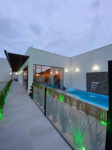 a swimming pool in the backyard of a house at Pousada Caminho Dos Sonhos in Penha