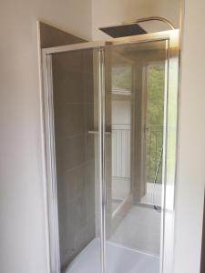 a shower with a glass door in a room at Valle B&B in Castelgomberto