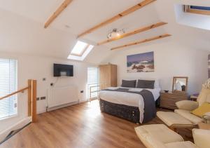 a bedroom with a bed and a living room at The Old Net Store - Cosy Anstruther Studio Flat in Cellardyke