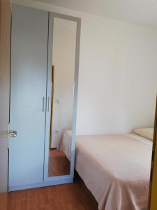 a bedroom with a door leading to a bed at Apartments Nikolina in Posedarje