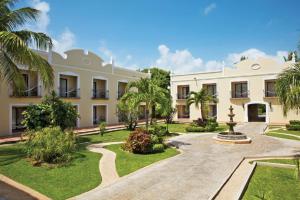 an exterior view of a building with palm trees at Dreams Tulum Resort & Spa in Tulum
