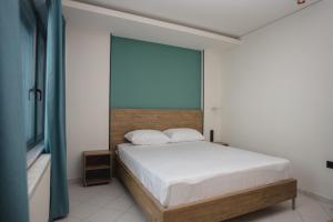 a bedroom with a bed and a large window at Passenger in Alexandroupoli