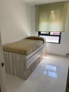 ein Schlafzimmer mit einem Bett in der Ecke eines Zimmers in der Unterkunft Atico playa Moncofar in Moncófa