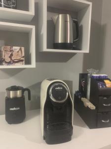 a kitchen counter with a toaster and a coffee maker at Le stanze di Dalia in Crotone