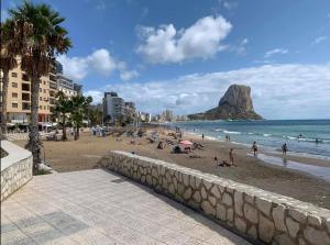 a beach with people on the sand and the ocean at Appartement de Jerry in Calpe