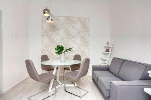 ein Wohnzimmer mit einem Tisch und einem Sofa in der Unterkunft Mamo Florence - Velluti Apartment in Florenz