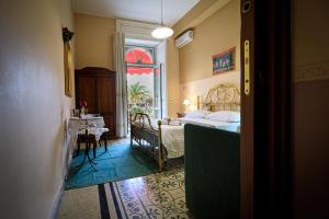 a bedroom with a bed and a table and a window at Sweet Suite V&V in Pompei