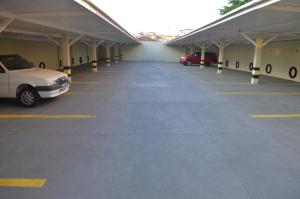 a large parking lot with cars parked in it at Itália Hotel in Telêmaco Borba
