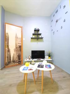 two tables in a living room with birds on the wall at N&N's Luxurious Suite #WhiteTower in Thessaloniki