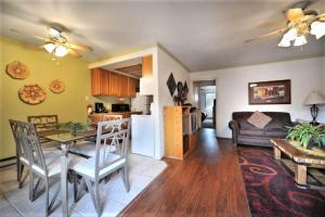 a kitchen and living room with a table and a couch at Pinecliff Village Resort in Ruidoso