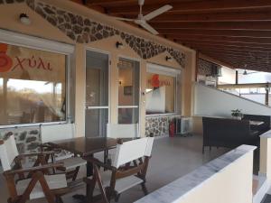a dining room with a table and chairs at Kohyli Apartments in Skala Rachoniou