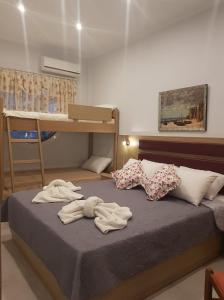 a bedroom with a bed with towels on it at Kohyli Apartments in Skala Rachoniou